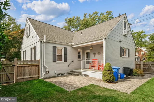 a view of house with backyard and sitting area