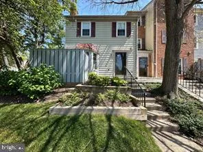 a view of house with backyard and sitting area