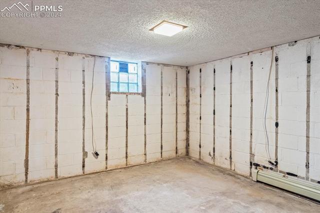 28018 County Farm Road Pueblo, CO 81006 - Photo 28 of 50 Basement with a baseboard radiator and a textured ceiling