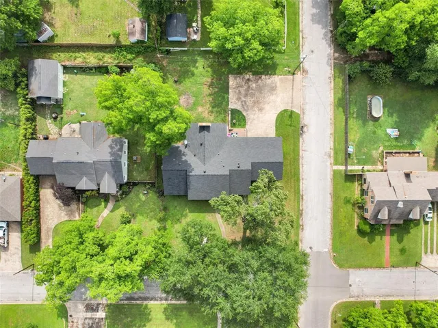 an aerial view of a house with a yard basket ball court and outdoor seating