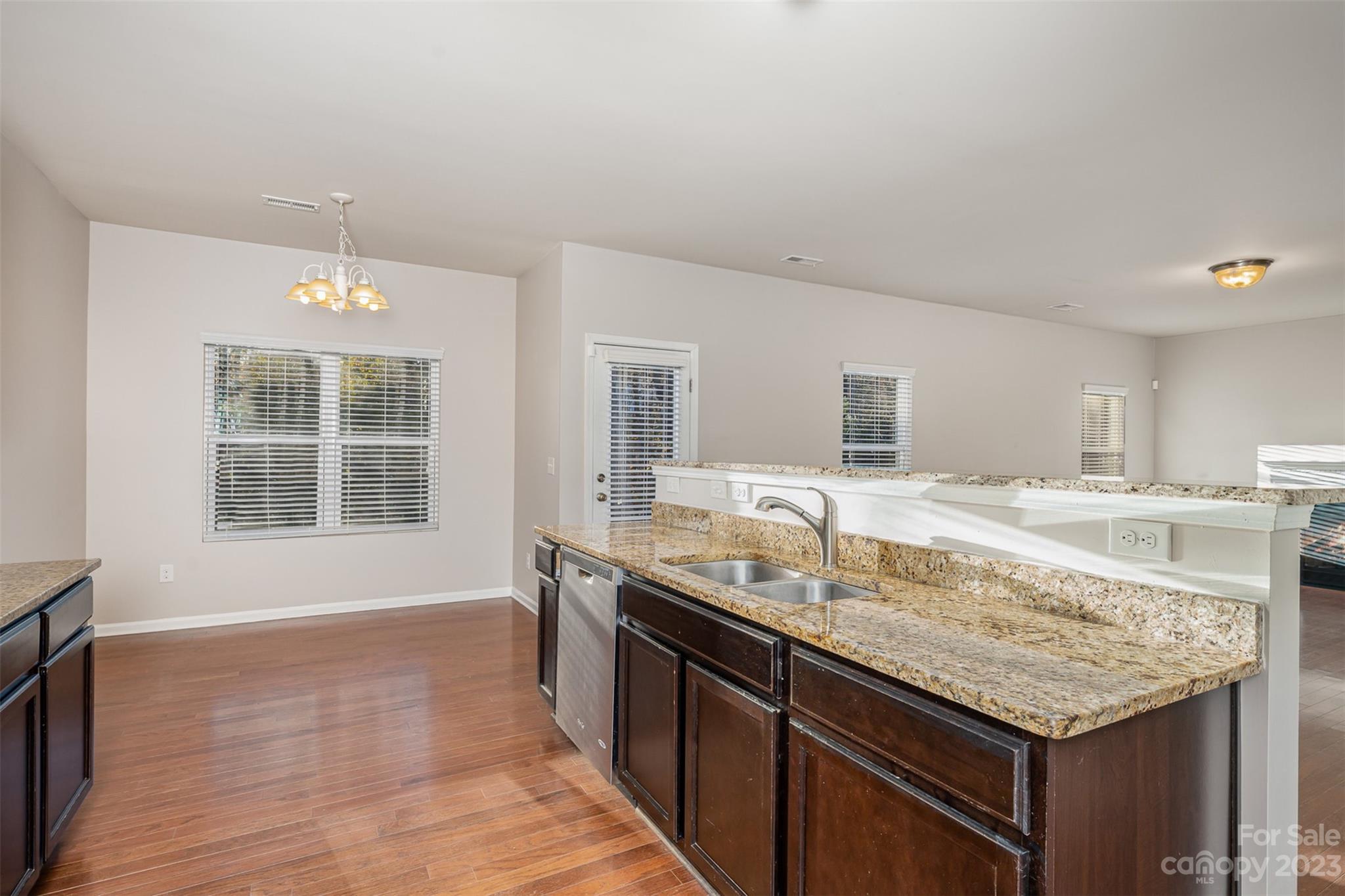13225 Chelsea Ridge Lane Huntersville, NC 28078 - Photo 13 of 40 a kitchen with granite countertop kitchen island a sink appliances and a counter space