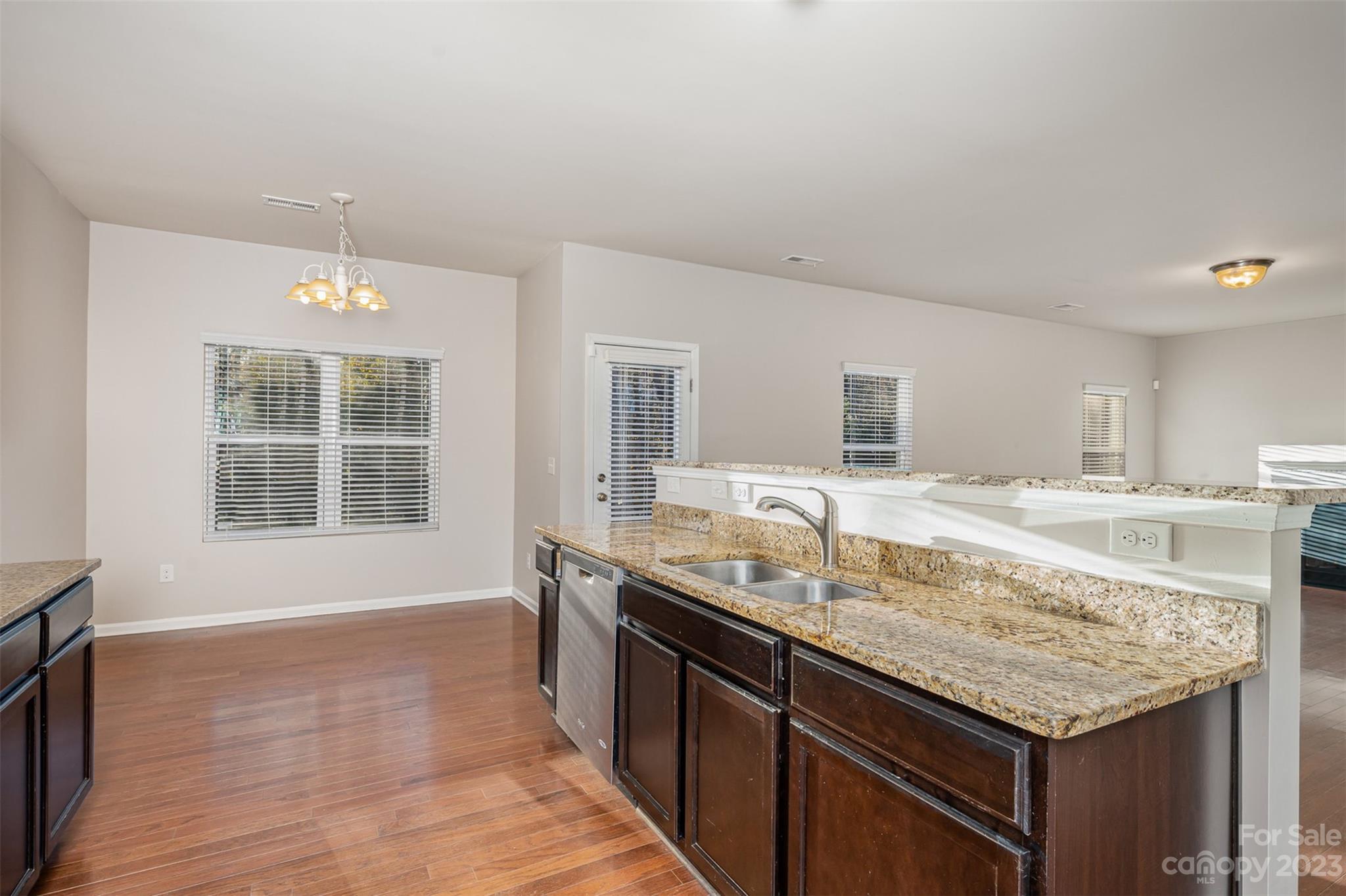 13225 Chelsea Ridge Lane Huntersville, NC 28078 - Photo 14 of 40 a kitchen with granite countertop kitchen island a sink appliances and a counter space