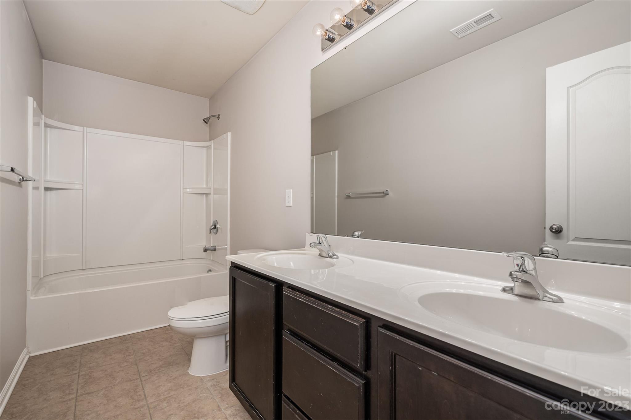 13225 Chelsea Ridge Lane Huntersville, NC 28078 - Photo 21 of 40 a bathroom with a granite countertop sink a toilet and shower