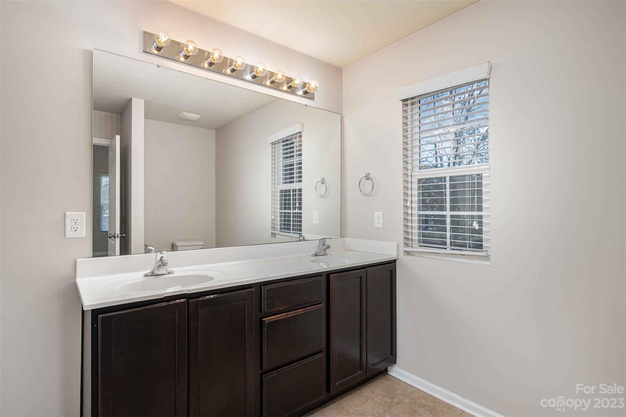 13225 Chelsea Ridge Lane Huntersville, NC 28078 - Photo 26 of 40 a bathroom with a double vanity sink and a mirror