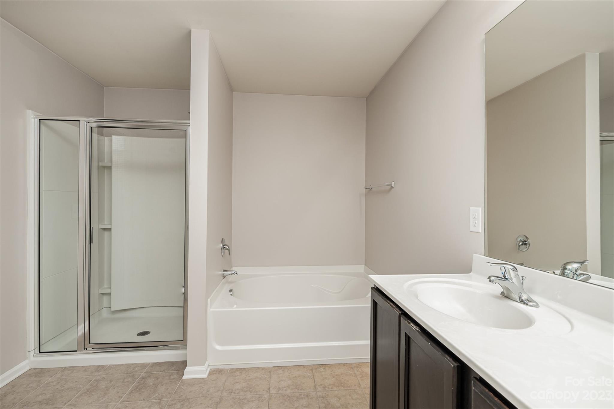 13225 Chelsea Ridge Lane Huntersville, NC 28078 - Photo 27 of 40 a bathroom with a tub sink vanity and mirror