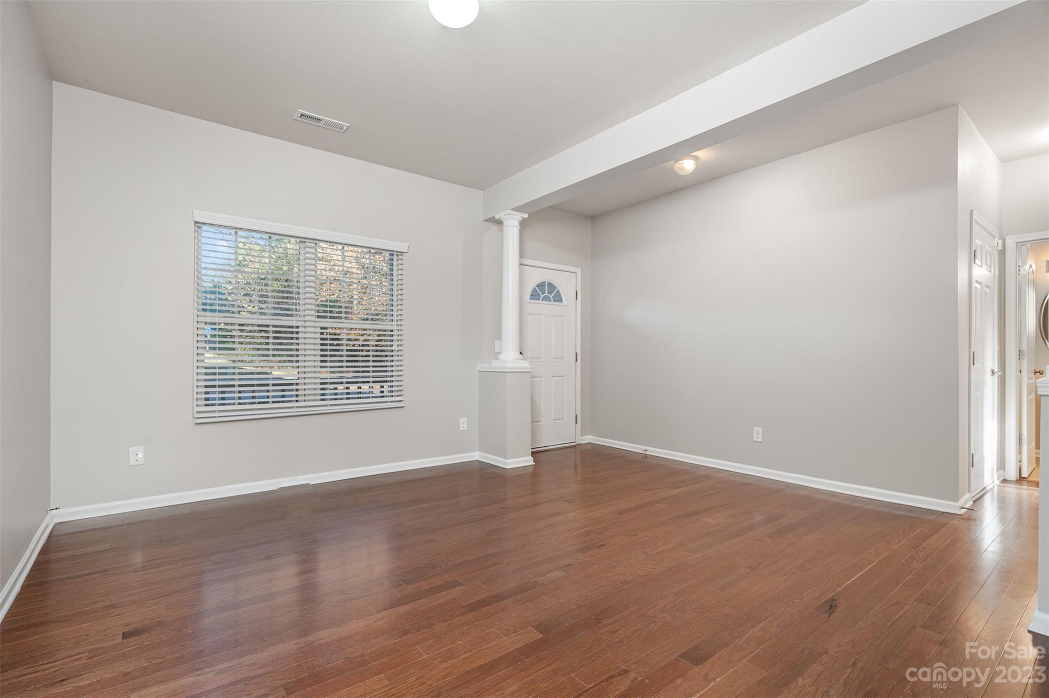 13225 Chelsea Ridge Lane Huntersville, NC 28078 - Photo 4 of 40 an empty room with wooden floor and windows