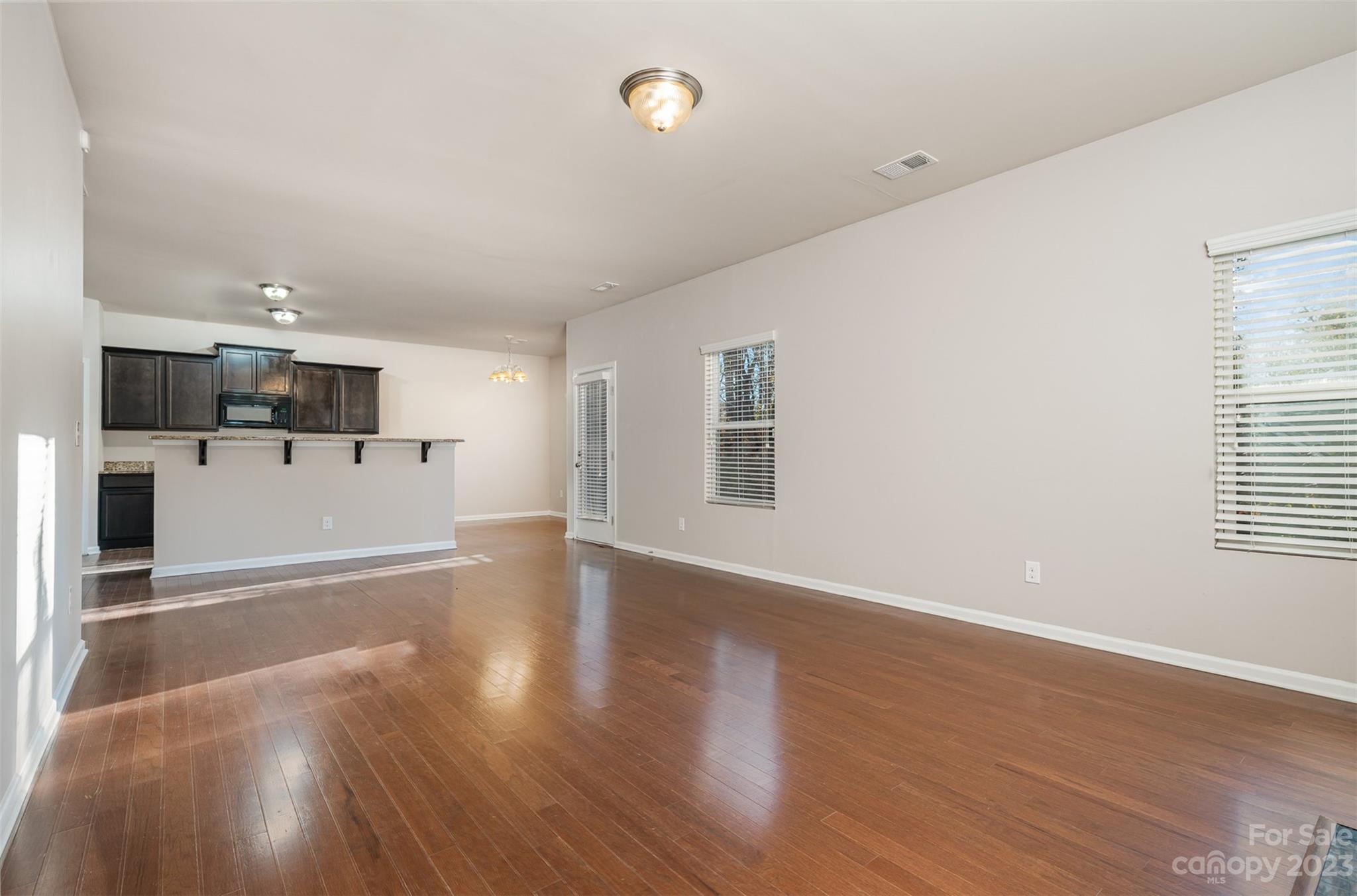 13225 Chelsea Ridge Lane Huntersville, NC 28078 - Photo 5 of 40 a view of a kitchen with wooden floor and electronic appliances