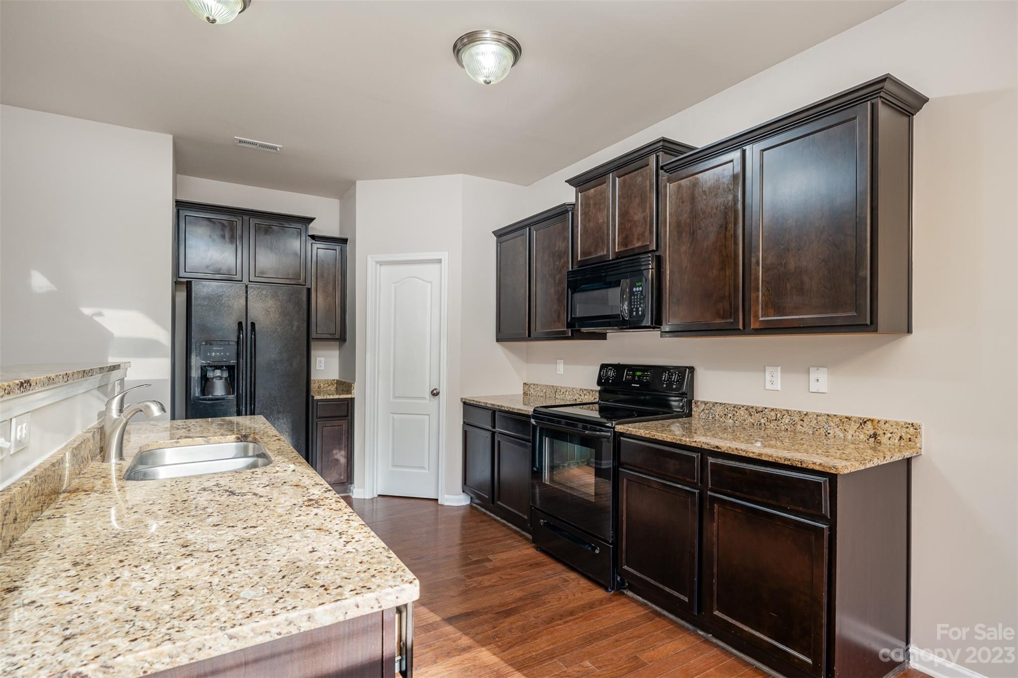 13225 Chelsea Ridge Lane Huntersville, NC 28078 - Photo 10 of 40 a kitchen with stainless steel appliances granite countertop a sink stove and refrigerator