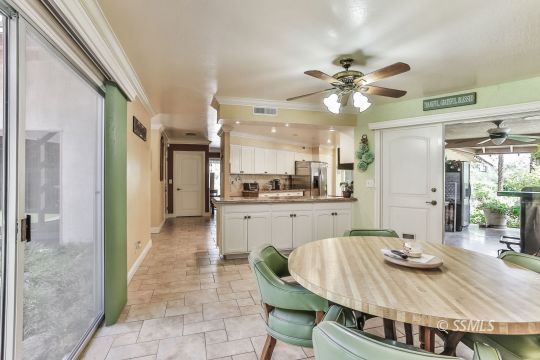 1509 Welcome Way Ridgecrest, CA 93555 - Photo 20 of 50 a kitchen with stainless steel appliances granite countertop a sink a stove a dining table and chairs