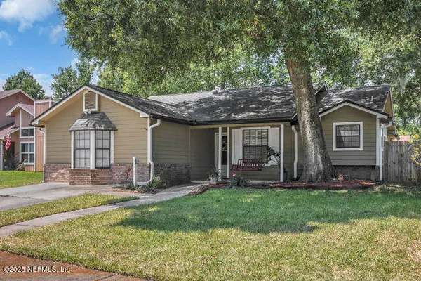 a front view of a house with a yard and porch