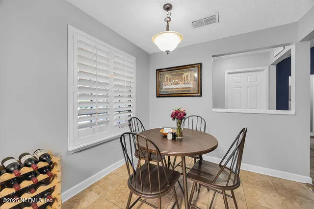 a view of a big room with wooden floor and windows