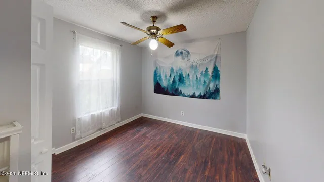 a spacious bedroom with a bed furniture and a ceiling fan