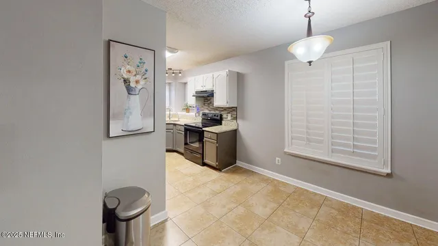 a view of a livingroom with an empty space and a window