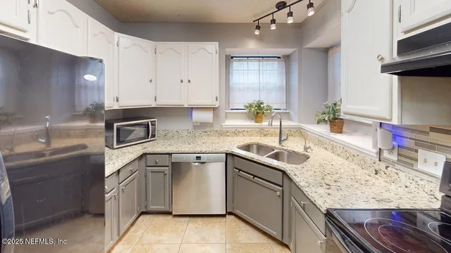 a kitchen with a sink stove and refrigerator