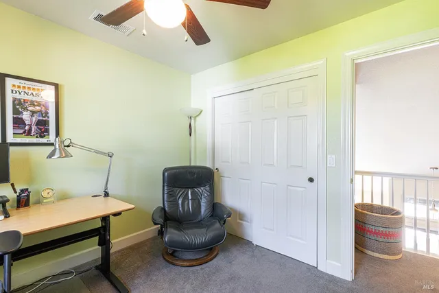 a living room with furniture and a chair