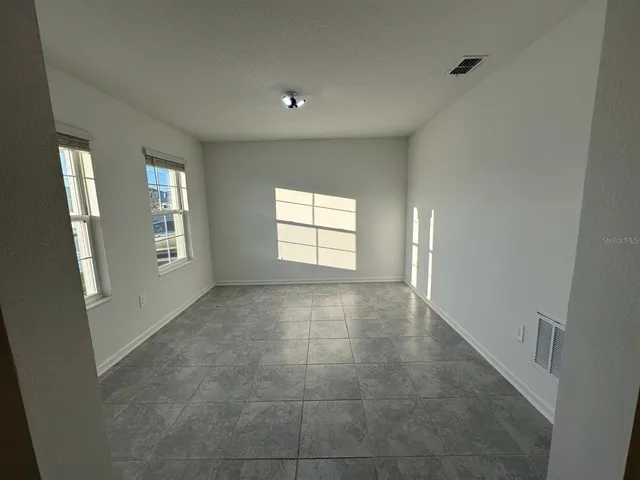 an empty room with windows and closet