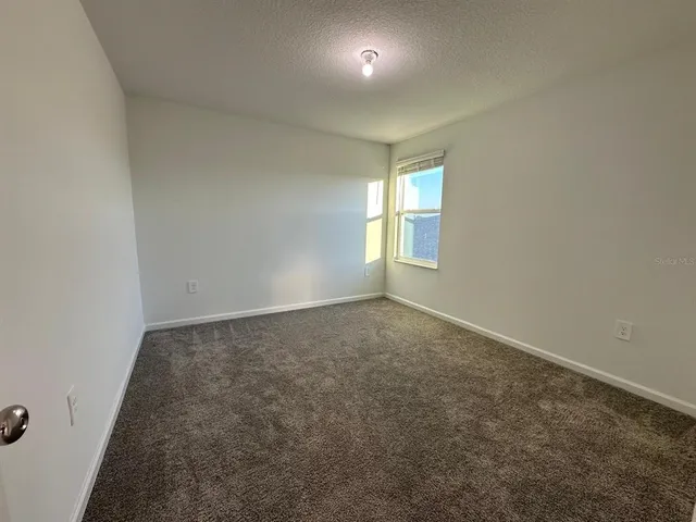 a white toilet sitting next to a bath tub and a shower