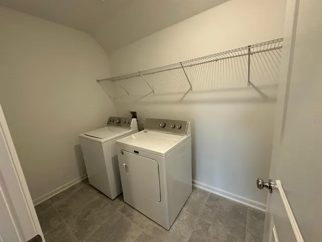 a view of a backyard with plants and a garden