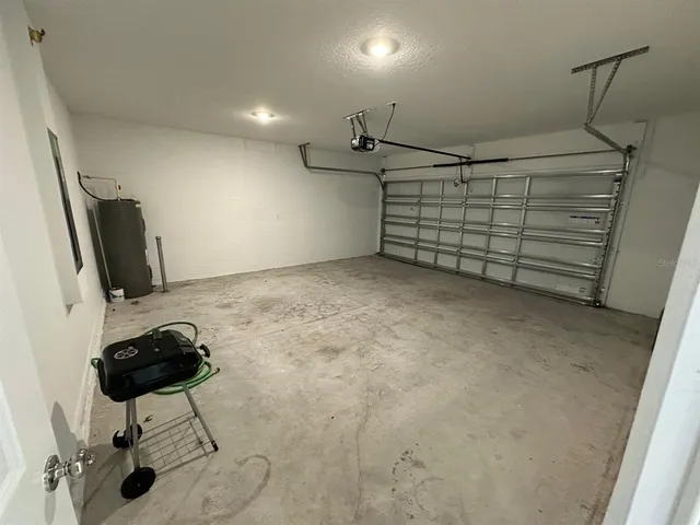 a black and white house with a yard in front of it