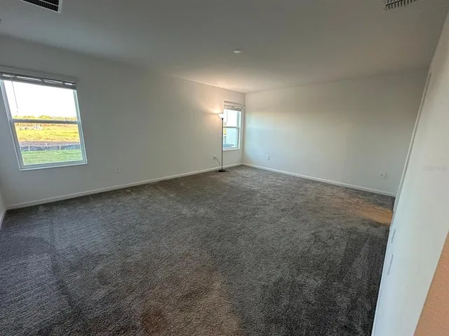 an empty room with a window and a fireplace