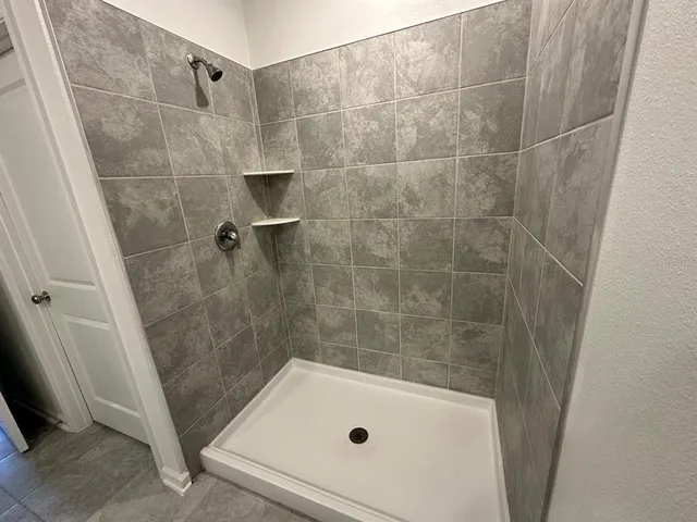a bathroom with a tub and a shower
