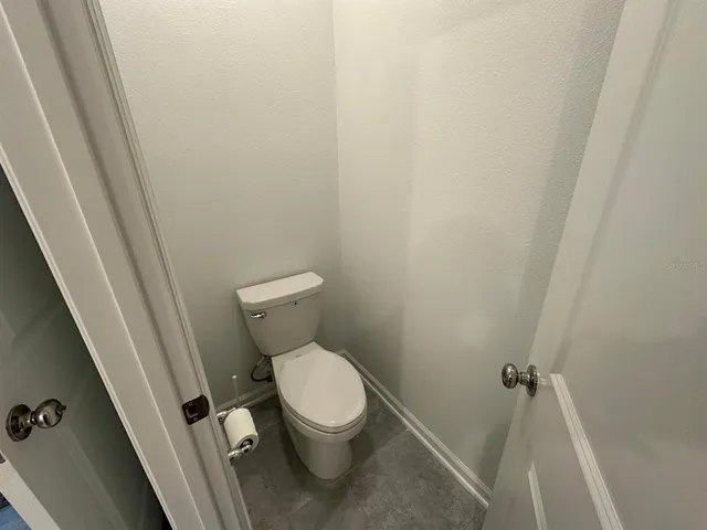 a white toilet sitting next to a sink