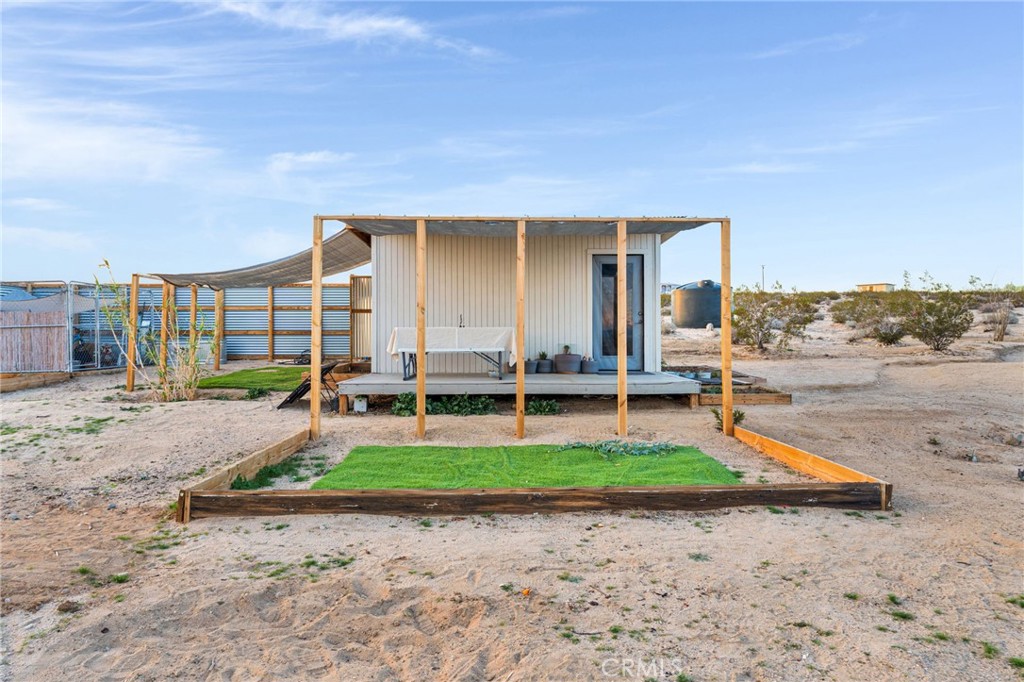 68476 Pole Line Road Twentynine Palms, CA 92277 - Photo 2 of 25 a backyard of a house with barbeque oven table and chairs