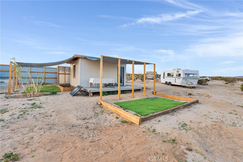 68476 Pole Line Road Twentynine Palms, CA 92277 - Photo 3 of 25 a view of a house with backyard and porch