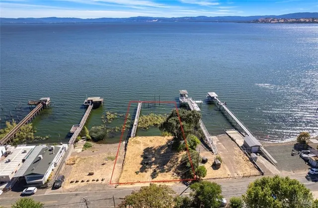 an aerial view of a house with a lake view
