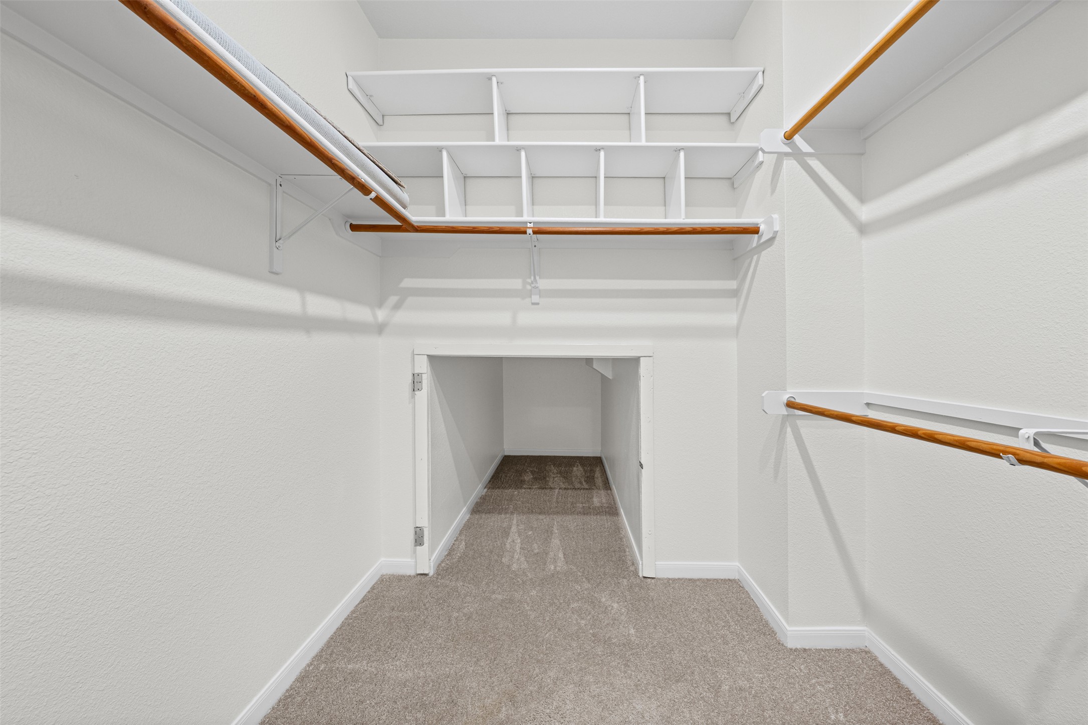 8820 Colberg Drive Austin, TX 78749 - Photo 21 of 35 Ample shelving and hanging rods provide extensive storage in this carpeted walk-in closet.
