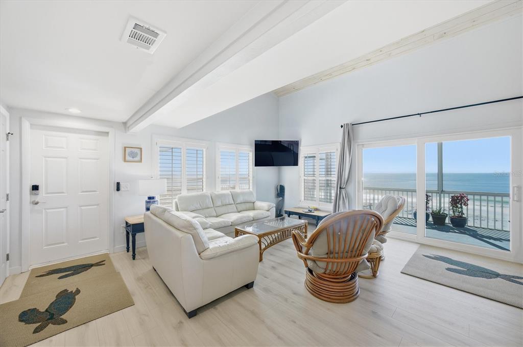 33 South Gulf Boulevard, Unit A Boca Grande, FL 33921 - Photo 18 of 47 a living room with furniture and a large window