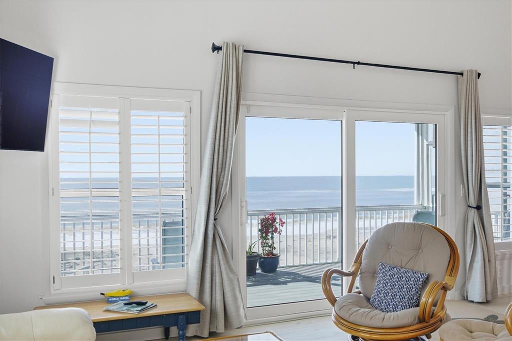 33 South Gulf Boulevard, Unit A Boca Grande, FL 33921 - Photo 19 of 47 a living room with furniture and a floor to ceiling window