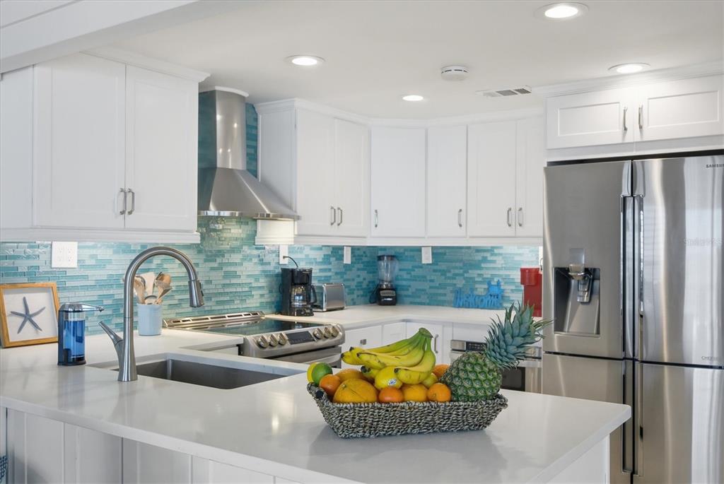 33 South Gulf Boulevard, Unit A Boca Grande, FL 33921 - Photo 28 of 47 a kitchen with stainless steel appliances granite countertop a sink and a refrigerator