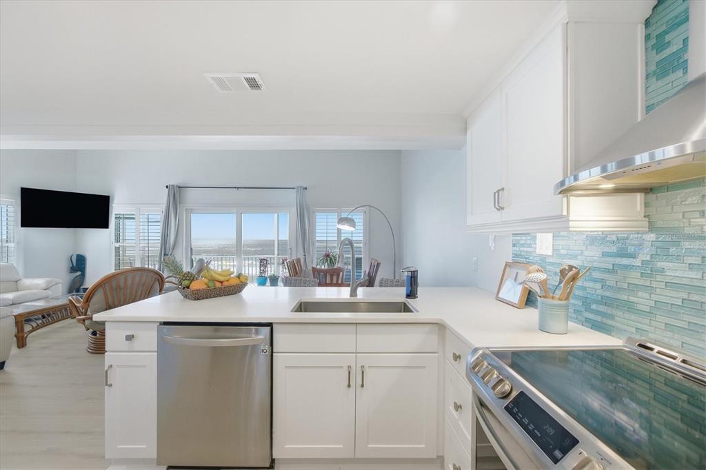 33 South Gulf Boulevard, Unit A Boca Grande, FL 33921 - Photo 29 of 47 a kitchen with a sink stove and cabinets