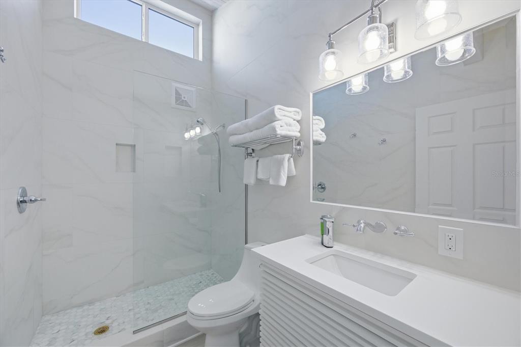 33 South Gulf Boulevard, Unit A Boca Grande, FL 33921 - Photo 33 of 47 a bathroom with a sink a toilet and shower