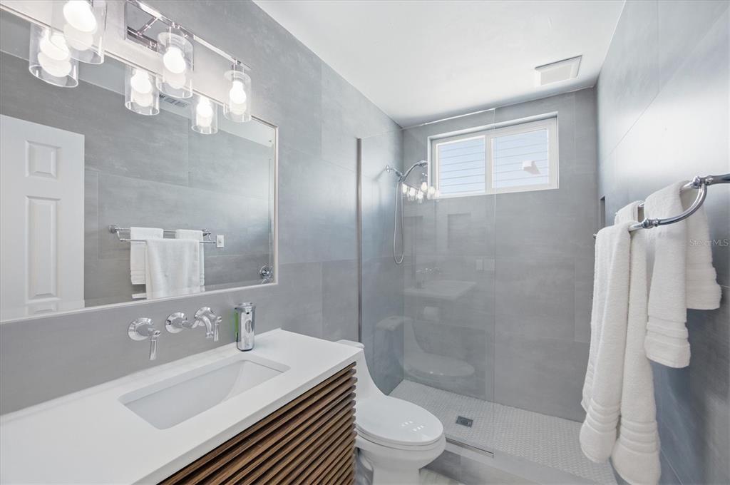 33 South Gulf Boulevard, Unit A Boca Grande, FL 33921 - Photo 35 of 47 a bathroom with a sink a toilet and shower