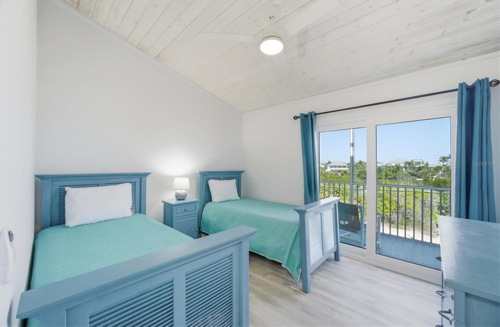 33 South Gulf Boulevard, Unit A Boca Grande, FL 33921 - Photo 36 of 47 a bedroom with two beds and large window