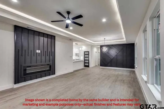 a view of an empty room and kitchen