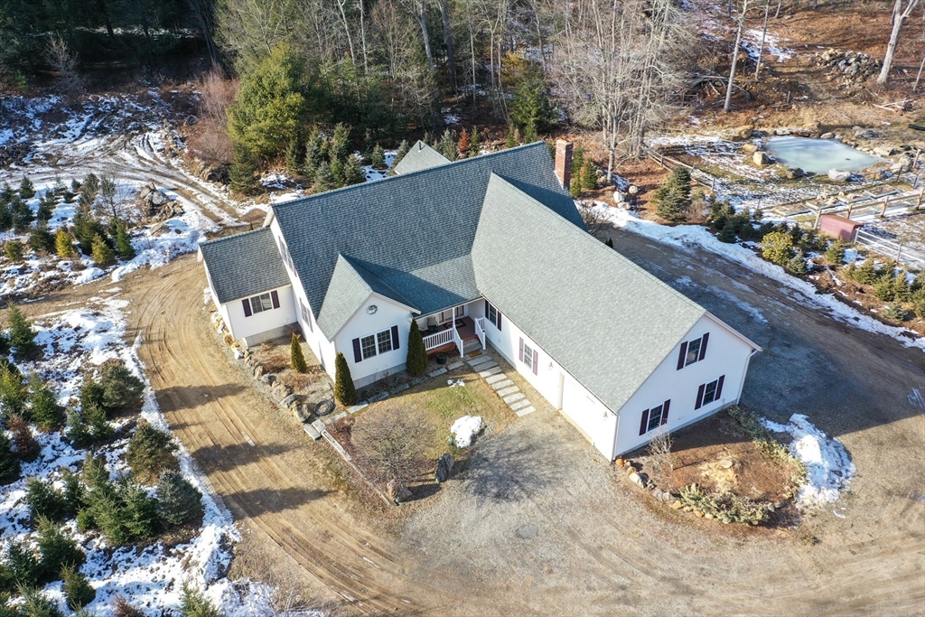 an aerial view of a house with a yard
