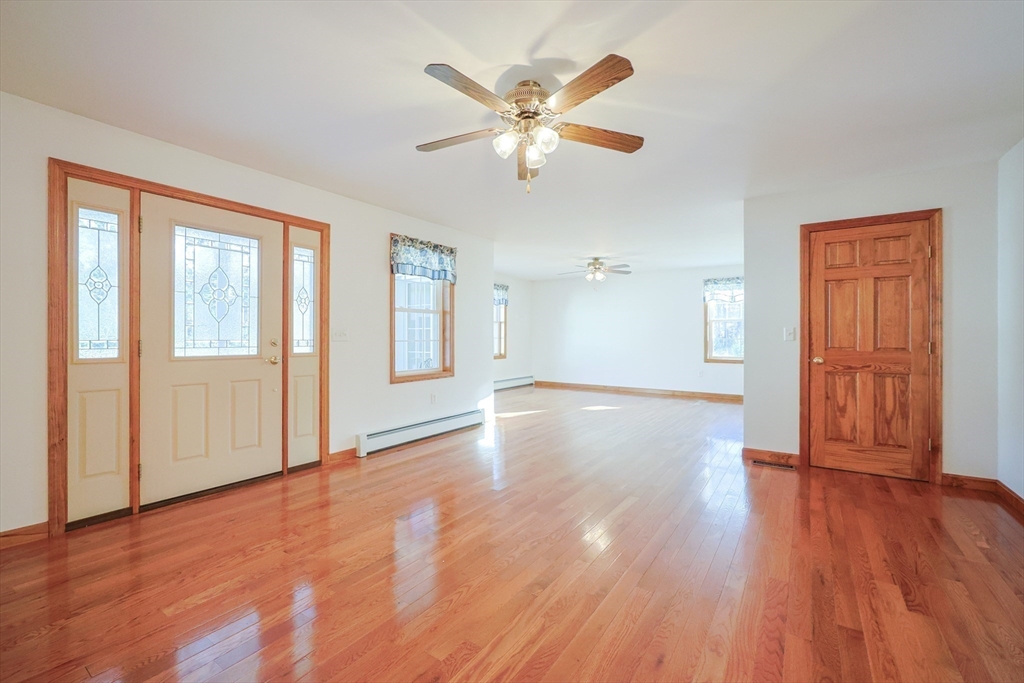 1380 North Brookfield Road Oakham, MA 01068 - Photo 11 of 37 a view of an empty room with wooden floor and a window
