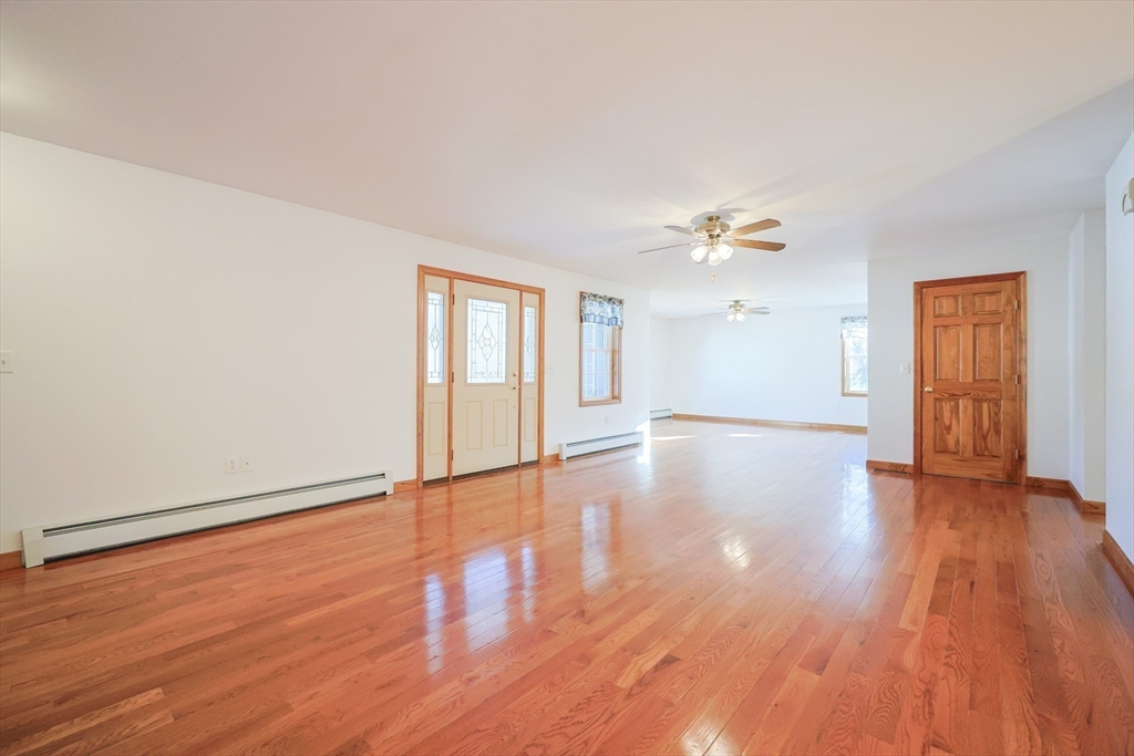 1380 North Brookfield Road Oakham, MA 01068 - Photo 12 of 37 a view of an empty room with wooden floor and a window