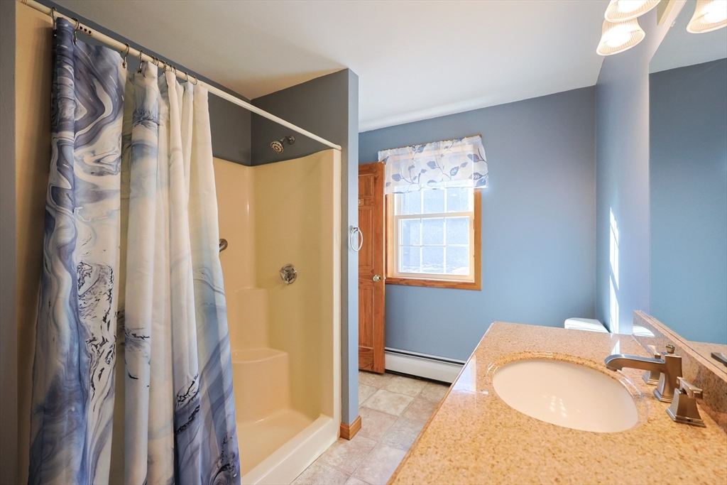 1380 North Brookfield Road Oakham, MA 01068 - Photo 17 of 37 a bathroom with a granite countertop sink and a mirror
