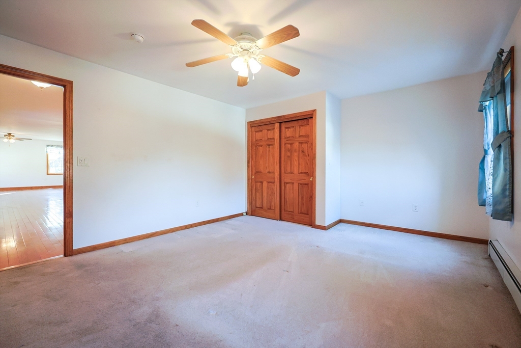 1380 North Brookfield Road Oakham, MA 01068 - Photo 18 of 37 an empty room with windows and fan