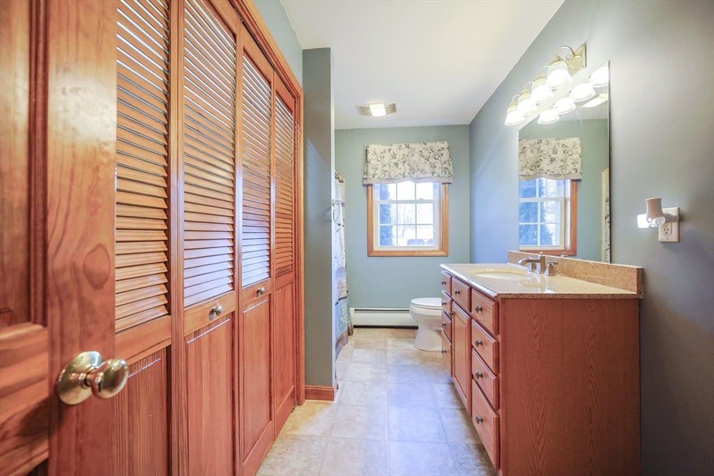 1380 North Brookfield Road Oakham, MA 01068 - Photo 20 of 37 a room with a balcony a sink and a dresser