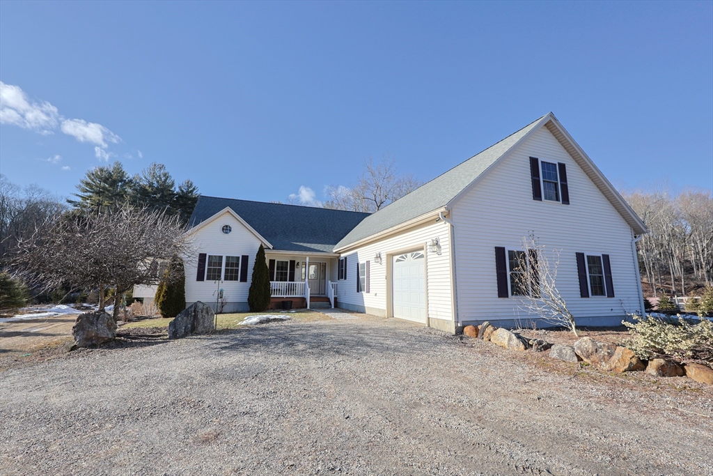 1380 North Brookfield Road Oakham, MA 01068 - Photo 3 of 37 a front view of a house with a yard and garage