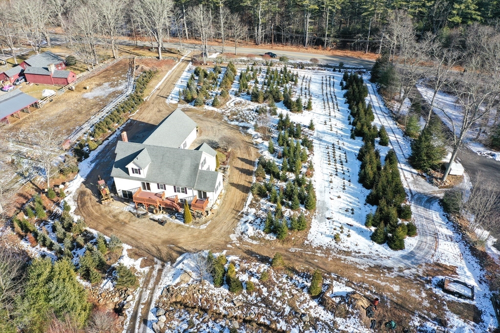 1380 North Brookfield Road Oakham, MA 01068 - Photo 36 of 37 an aerial view of a house with a yard and wooden floor