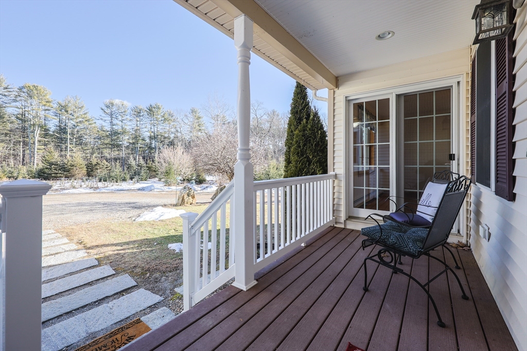 1380 North Brookfield Road Oakham, MA 01068 - Photo 6 of 37 a view of a balcony with chair and wooden floor