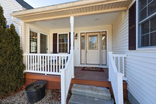 a porch with a bench next to a chair