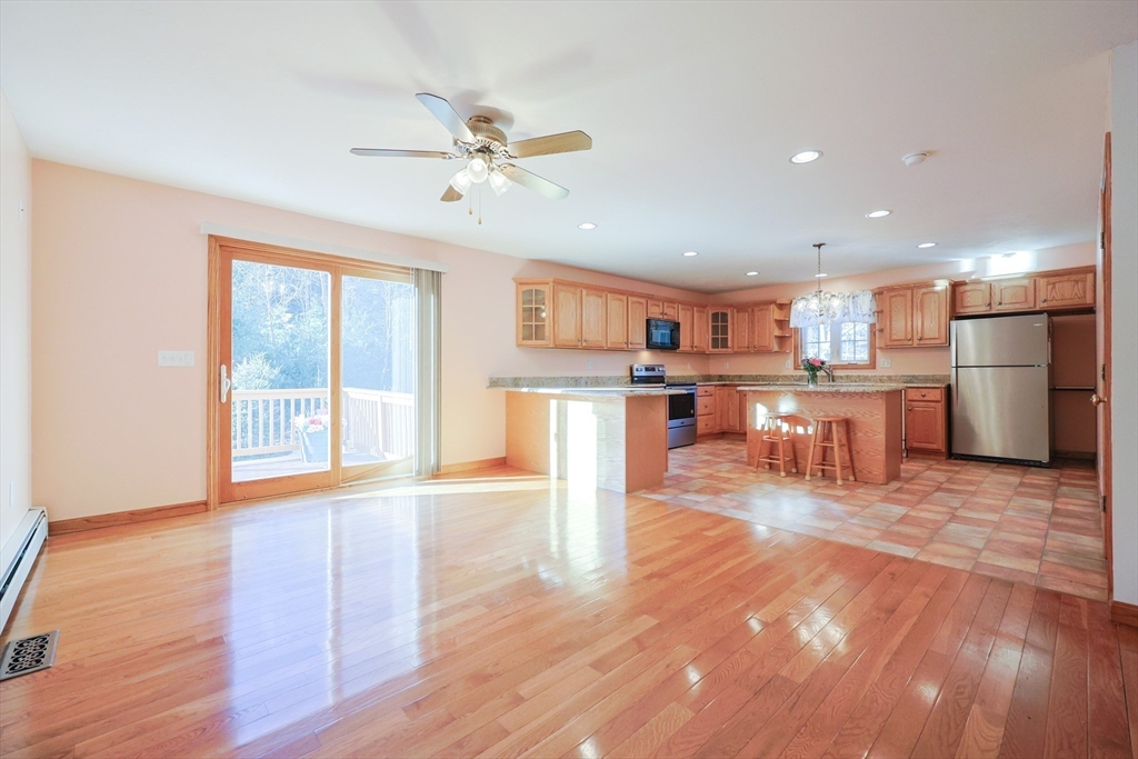 1380 North Brookfield Road Oakham, MA 01068 - Photo 9 of 37 a room with stainless steel appliances kitchen island granite countertop a stove top oven a sink and a refrigerator