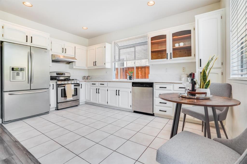 34372 Eucalyptus Terrace Fremont, CA 94555 - Photo 13 of 40 a kitchen with stainless steel appliances granite countertop a stove a sink dishwasher and a refrigerator